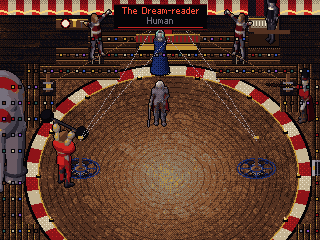 The Dream-reader holds the ring under the big top.
